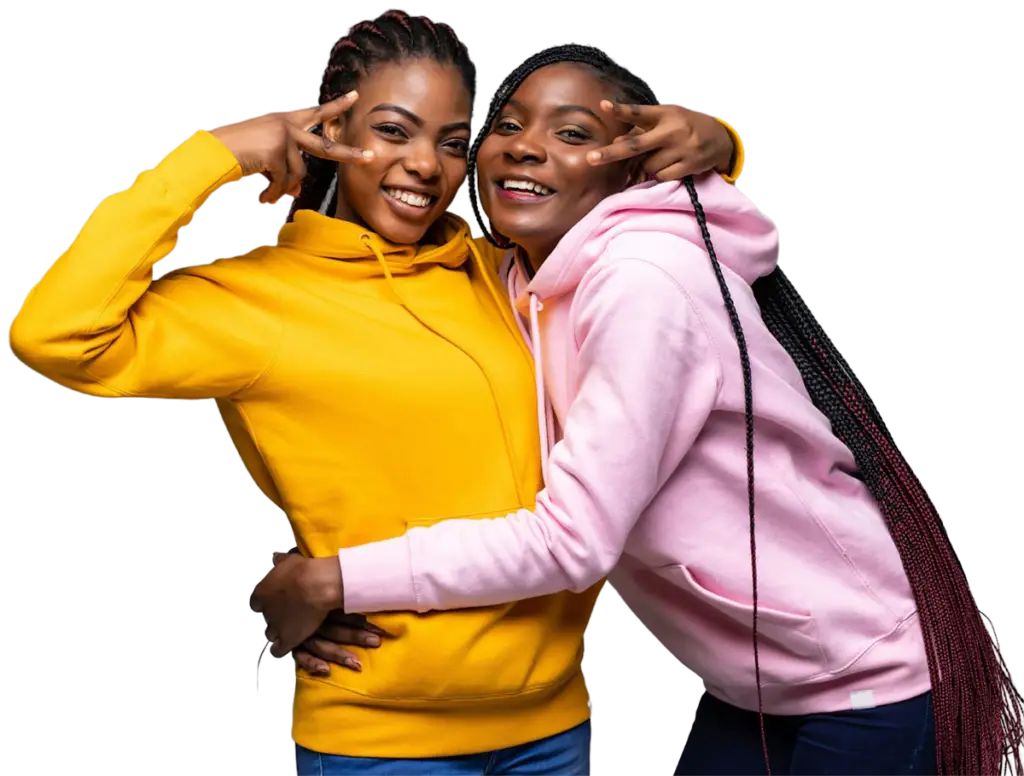 Two smiling friends in colorful hoodies embracing and posing playfully